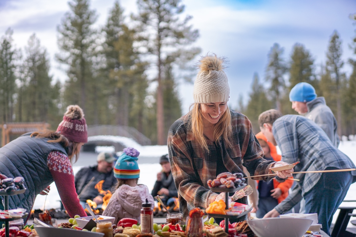 Family making s'mores around a firepit